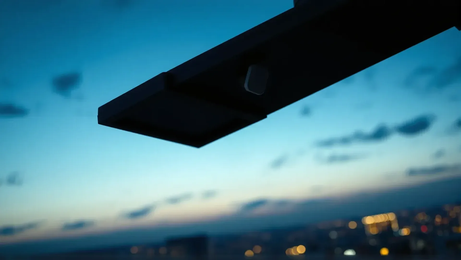 LED fixture with wireless sensor overlooking a commercial property at dusk
