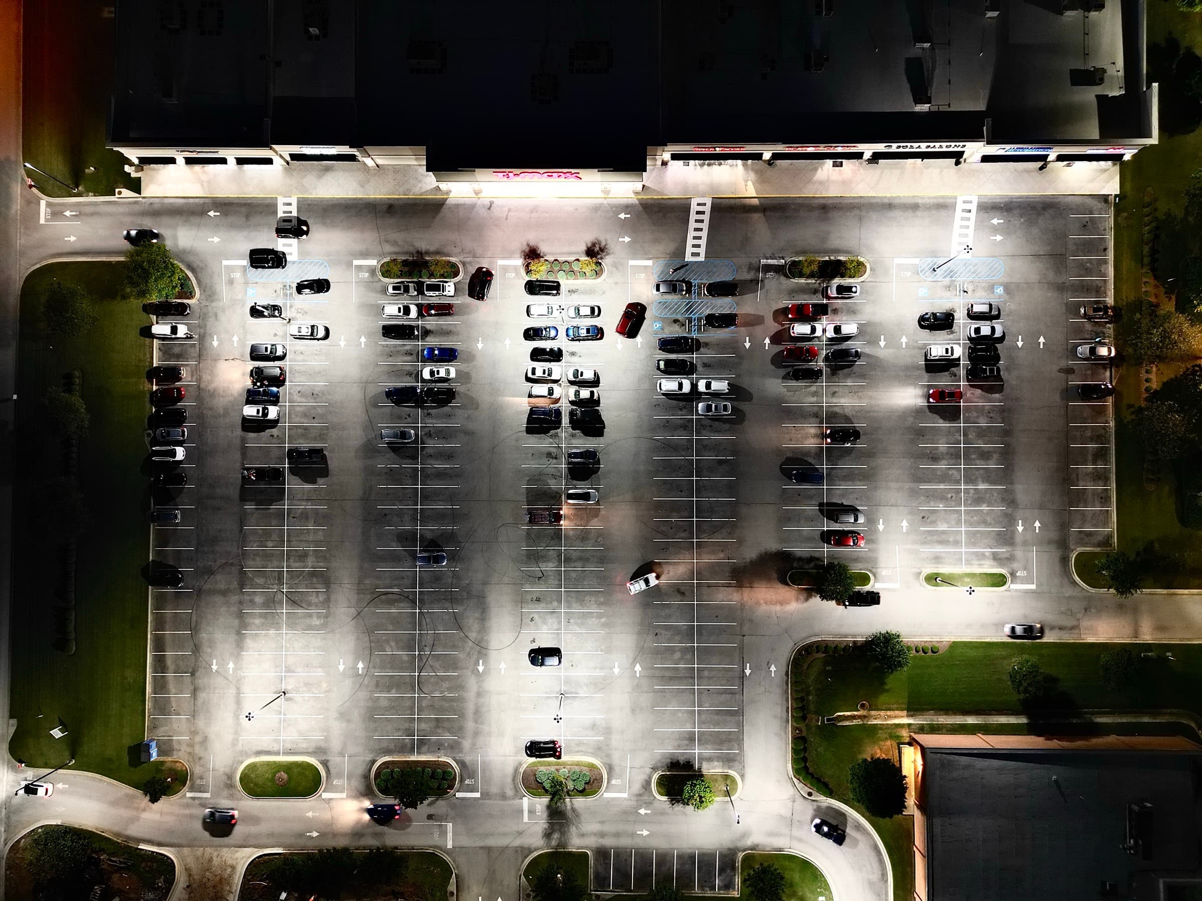 LED-lit retail parking lot at night